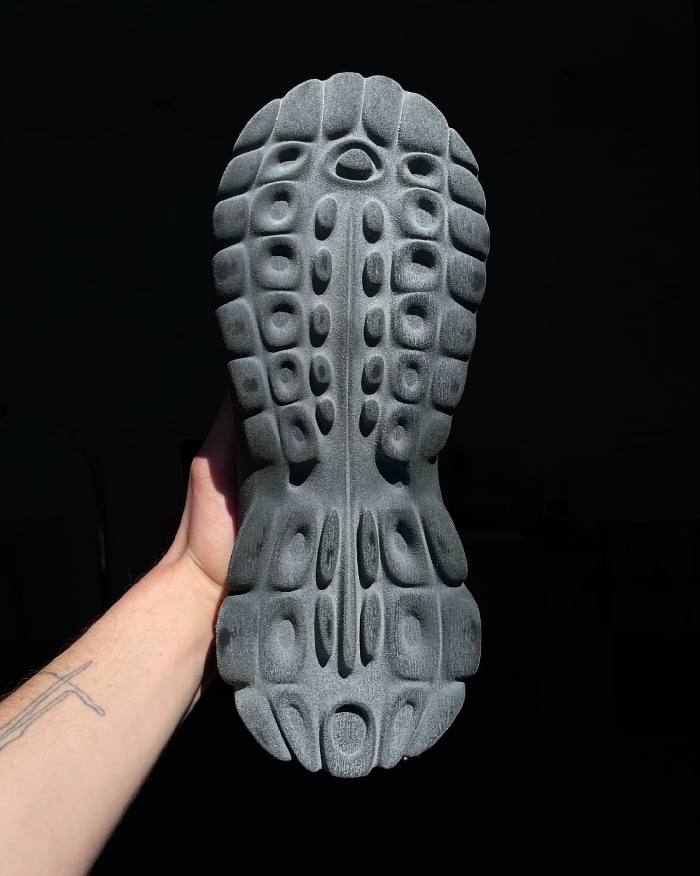 P100 outsole close-up showing the honeycomb-cavity tread