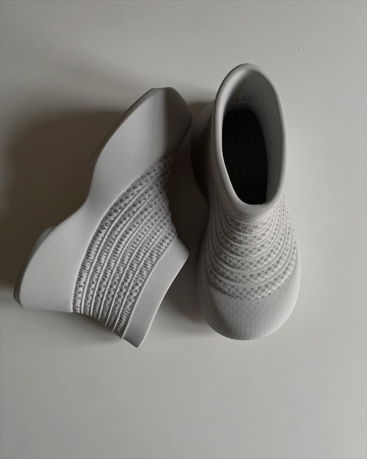 UOMD pair showing the ribbed mesh side panel and sock-style opening