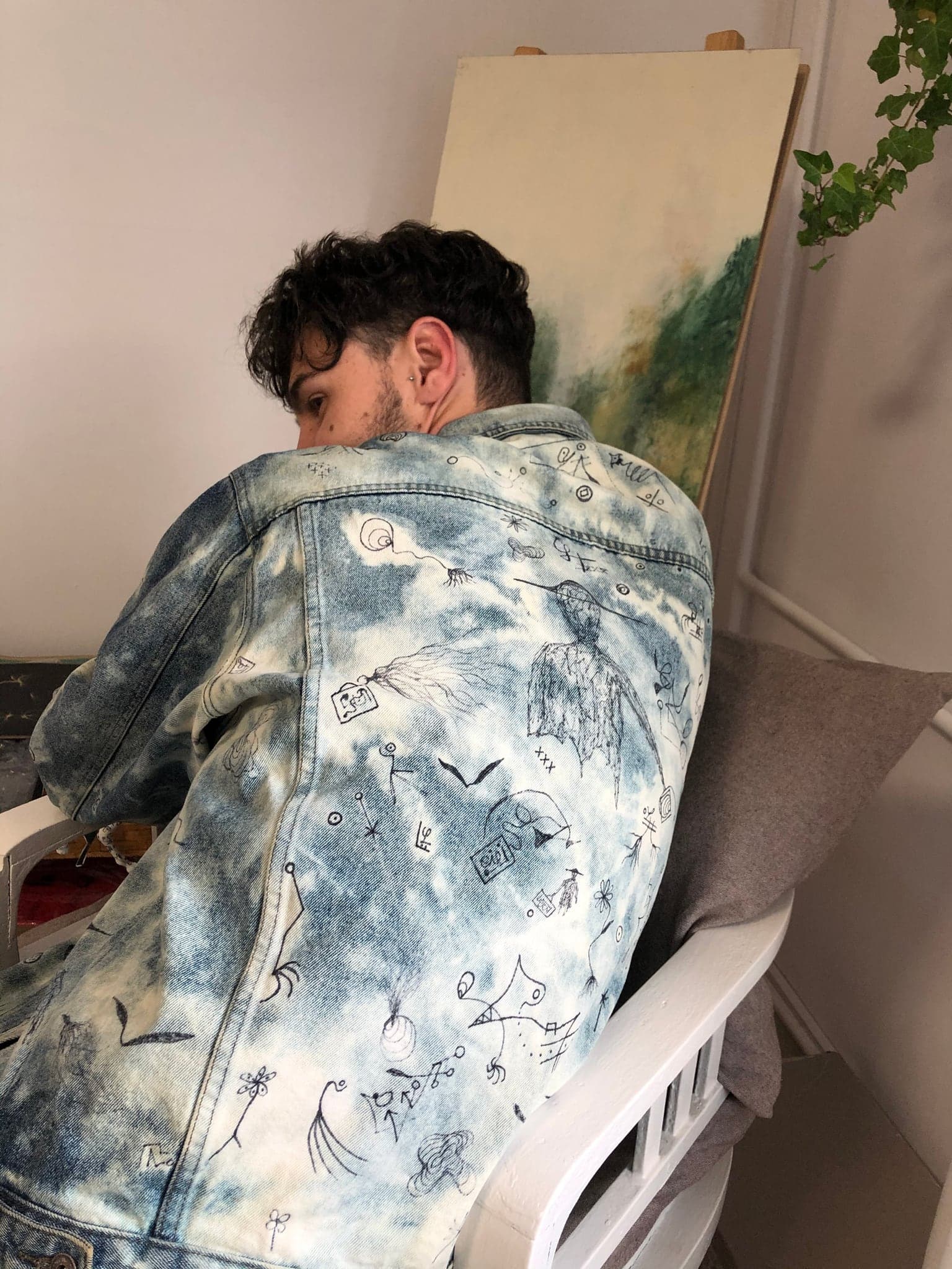The shoulder and sleeve of the jacket, drawings running down the arm