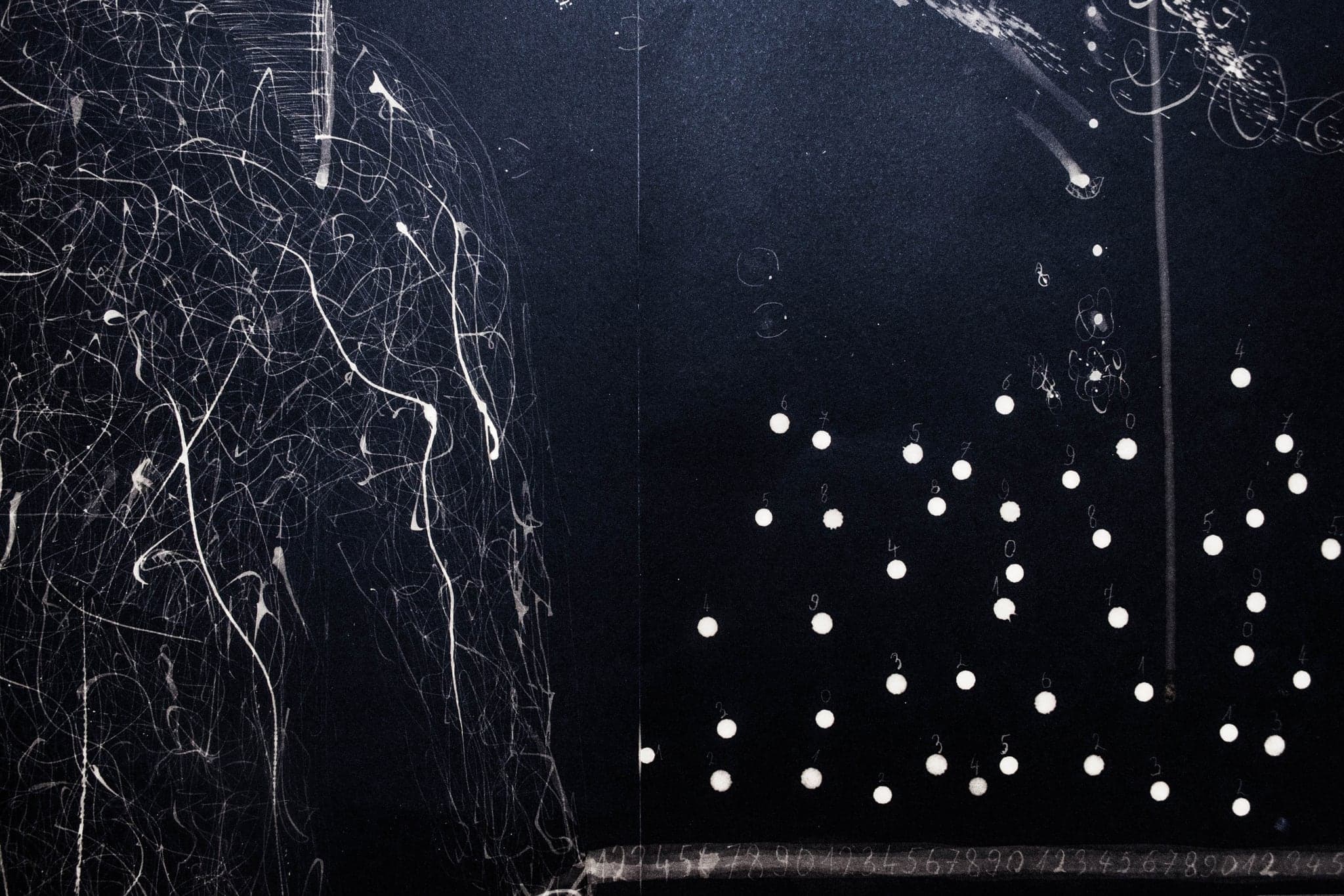 White dots scattered in a loose drift across deep blue, with a fine tangle of lines along the left edge.