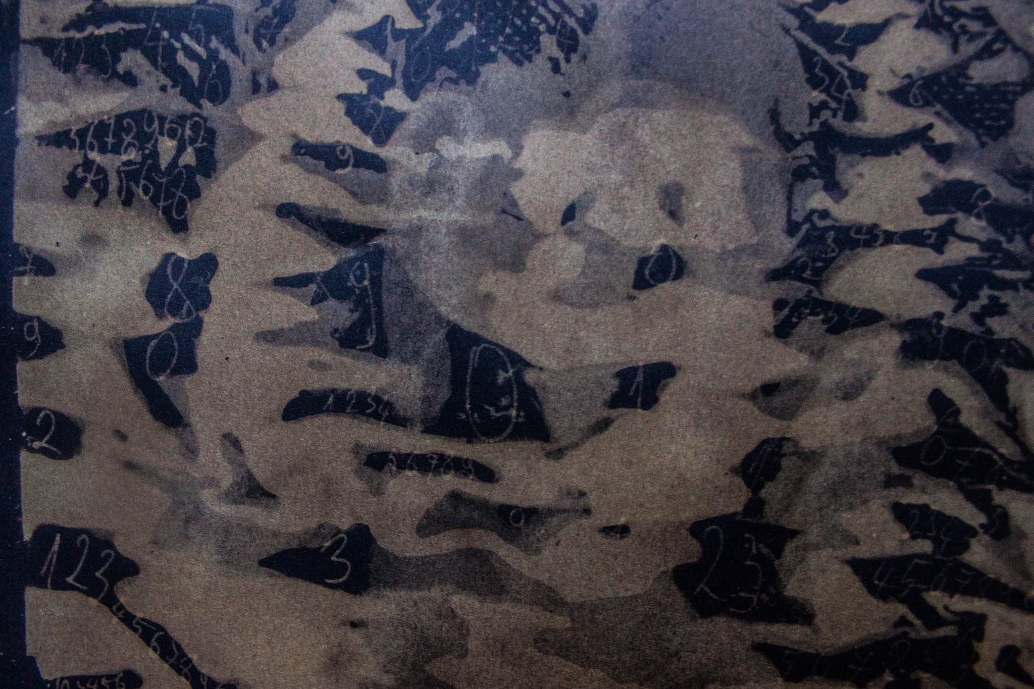 Pale blue and white, dense small leaf-like forms drifting across the sheet.