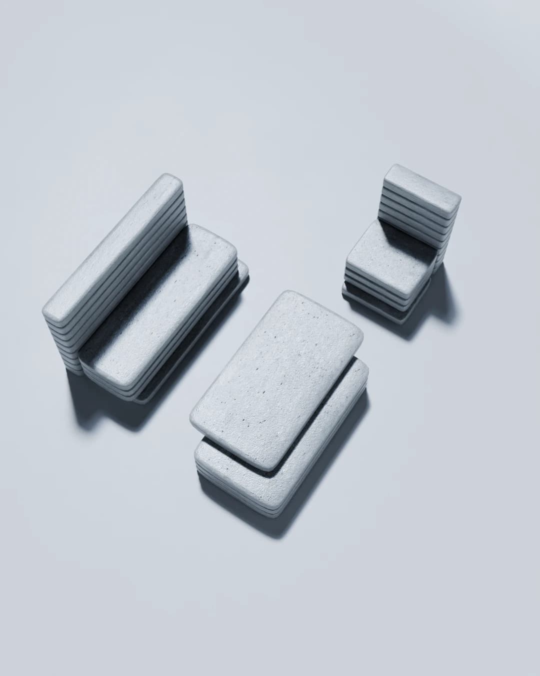 Overhead view of the full set, bench, chair and low table, all built from the same stacked concrete slab