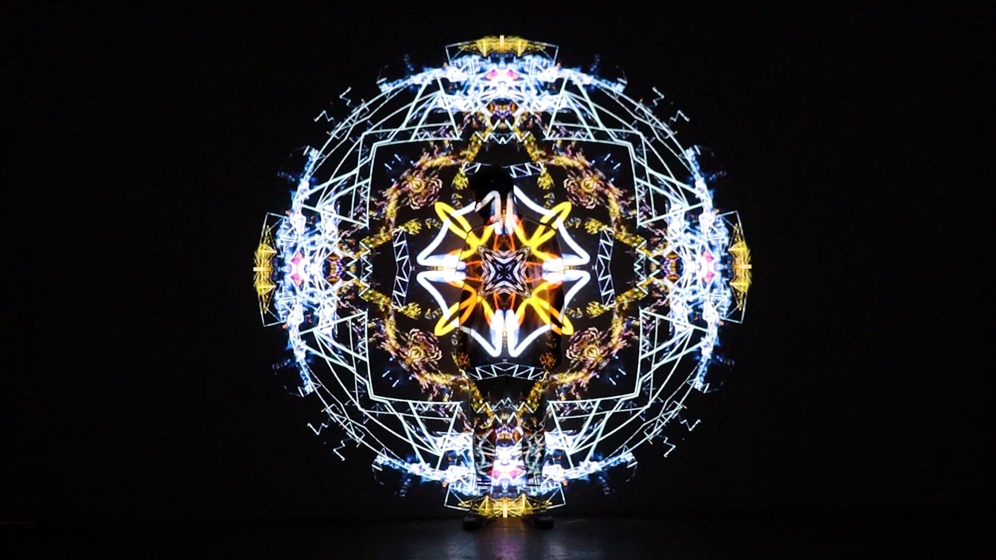 The cube dissolved into a sphere of white and gold wire geometry