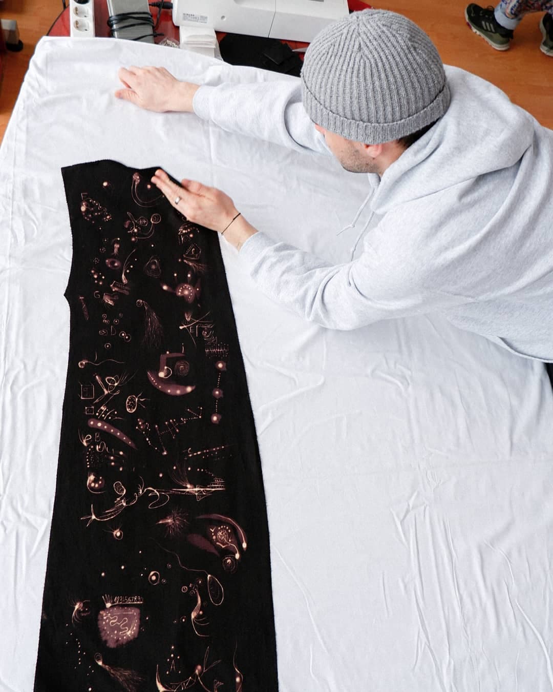 The garment laid flat while being worked on, marks drawn across the canvas