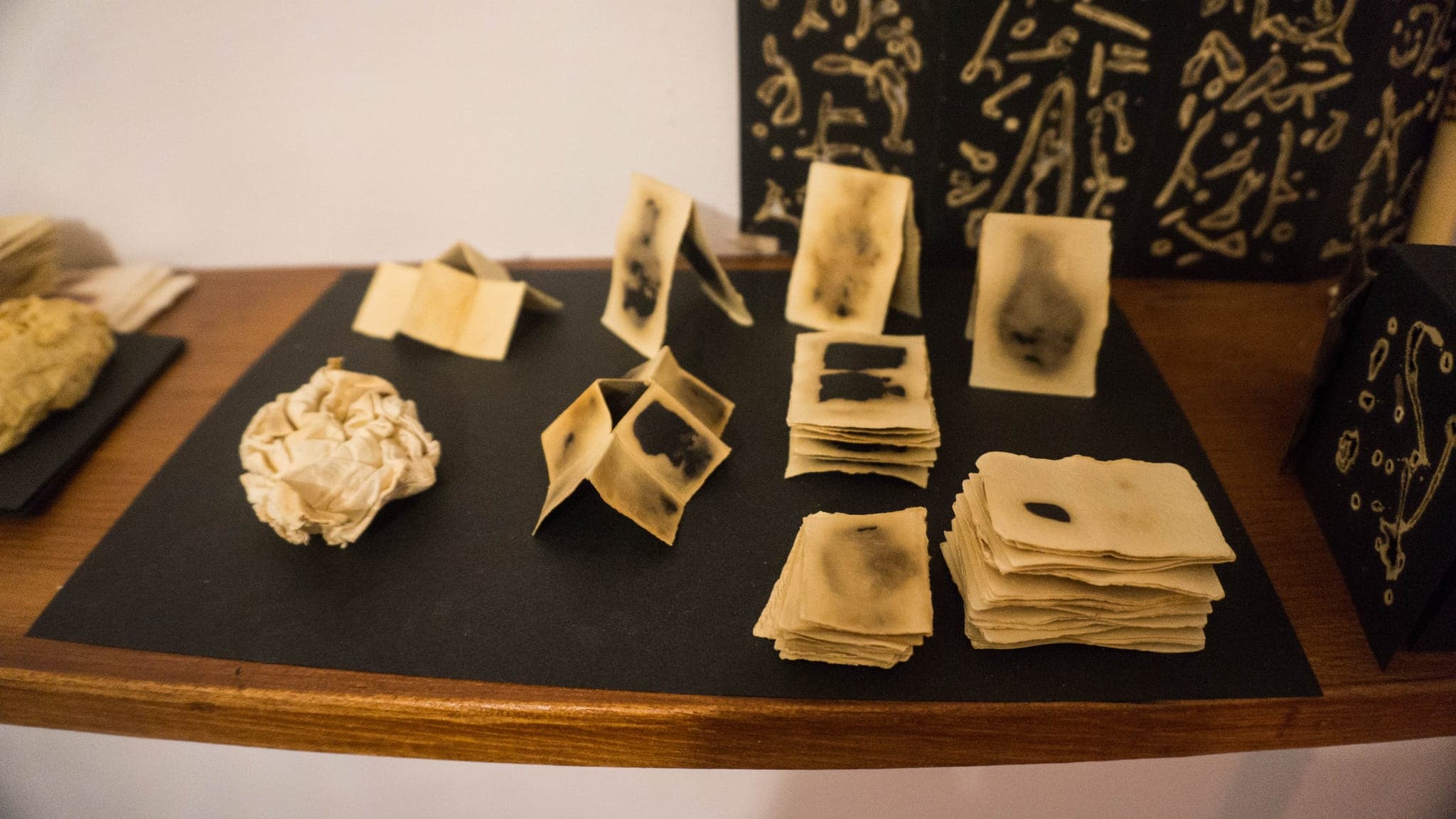 The same table from the other side, cards and one crumpled sheet among them.
