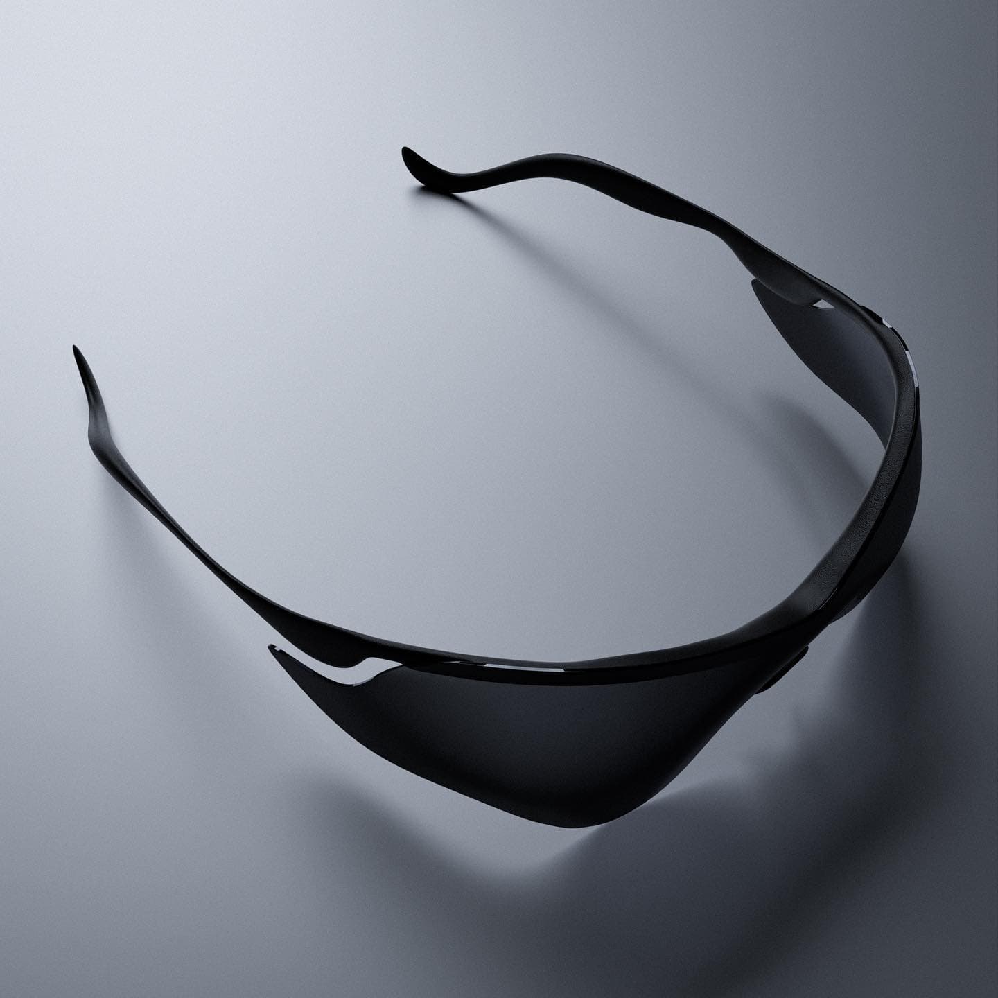 A matte black wraparound shade lying on a grey surface, one continuous sheet with no front frame