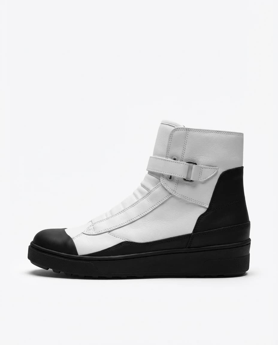 The Haematom boot in profile, white shaft, black toe cap and sole, single ankle strap