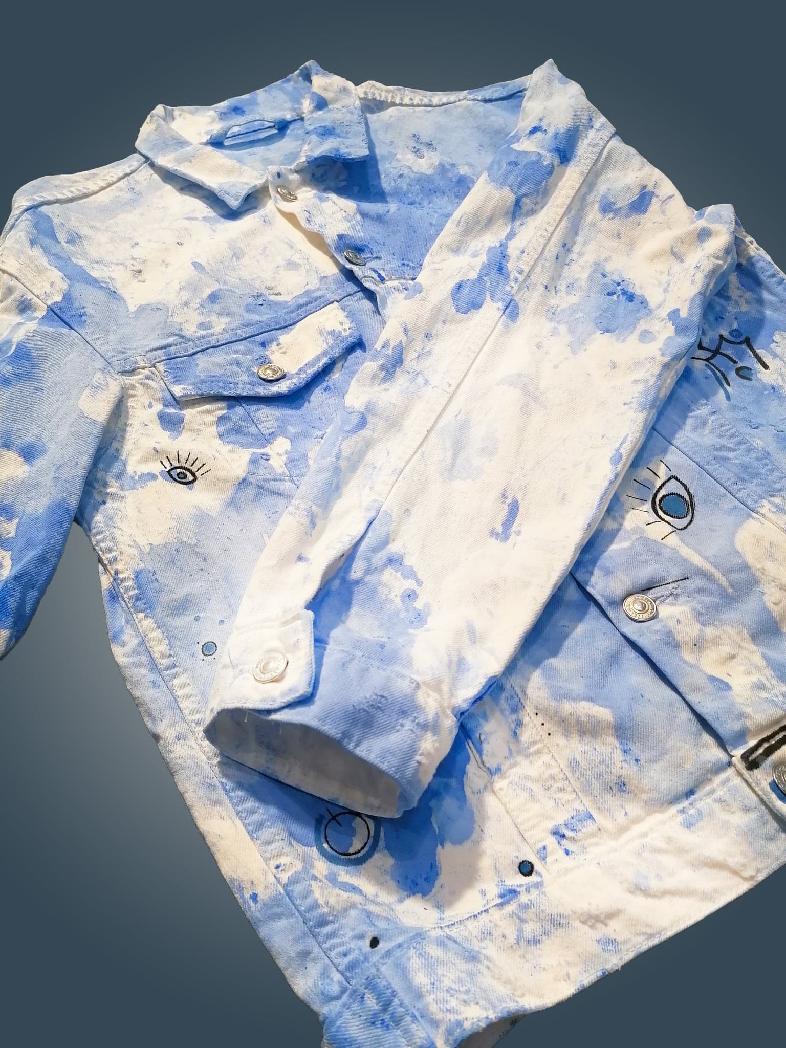 The jacket folded close, a second eye beside a button and the collar turned back