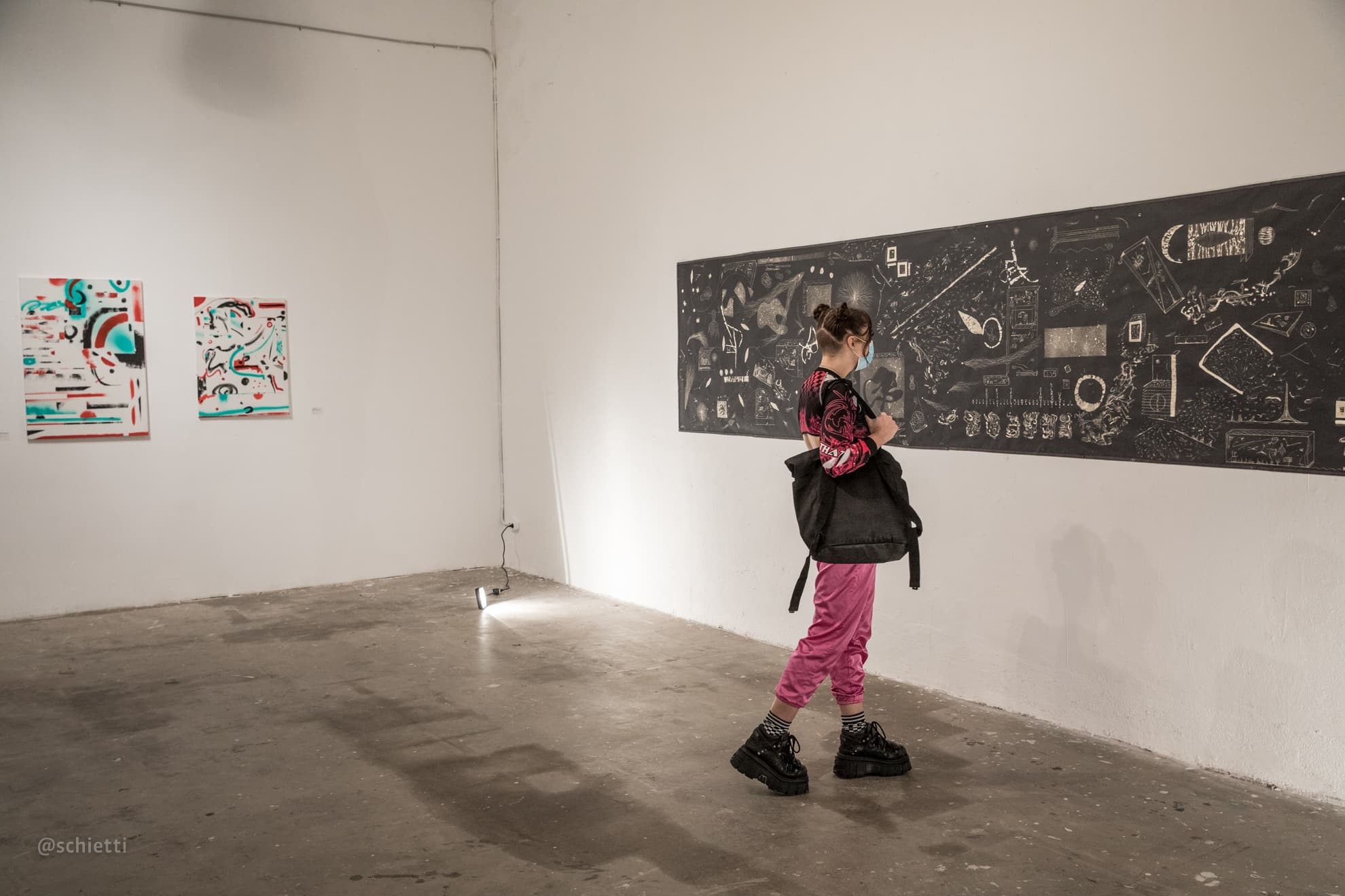 The room wide, the panel along one wall and two smaller works on the wall beside it