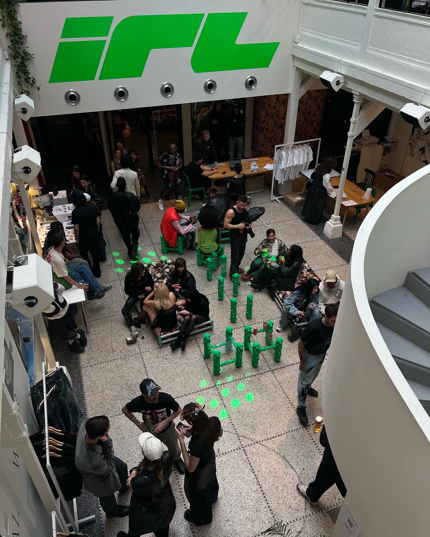 The showroom floor seen from above, visitors gathered around the displays