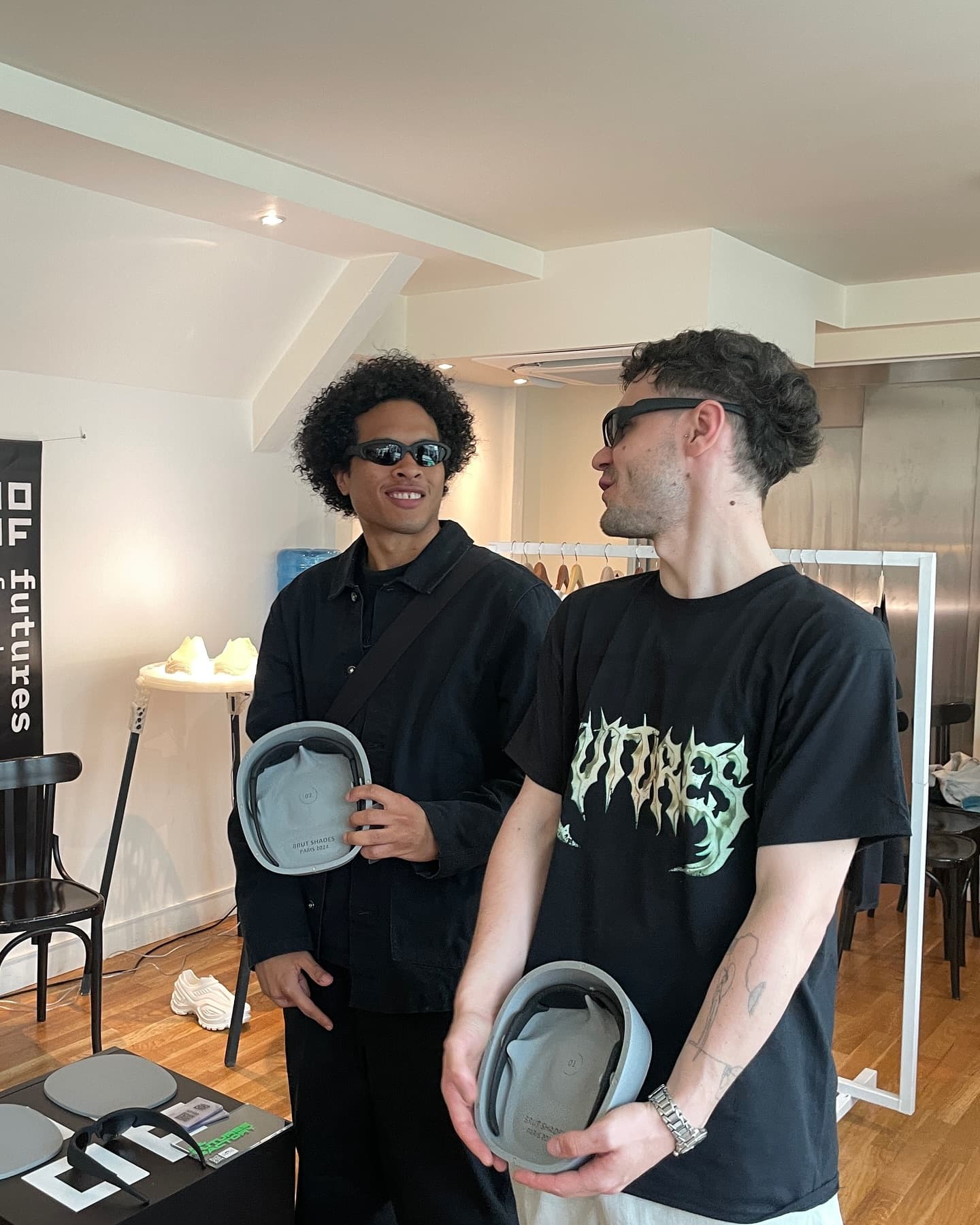 Two people in conversation at the showroom, one wearing the frames