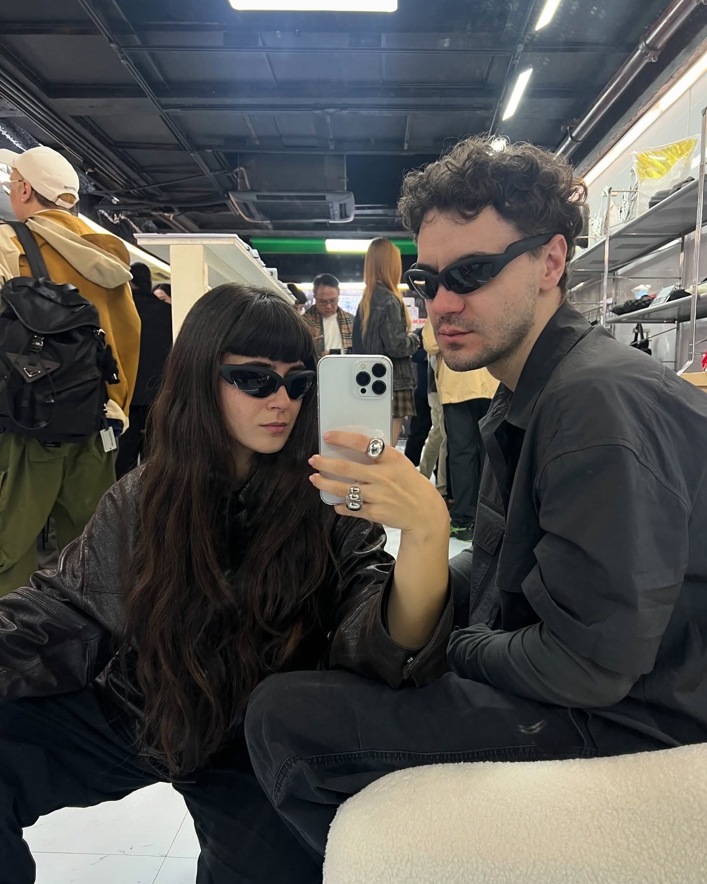 A guest photographing the room, another wearing the frames beside her