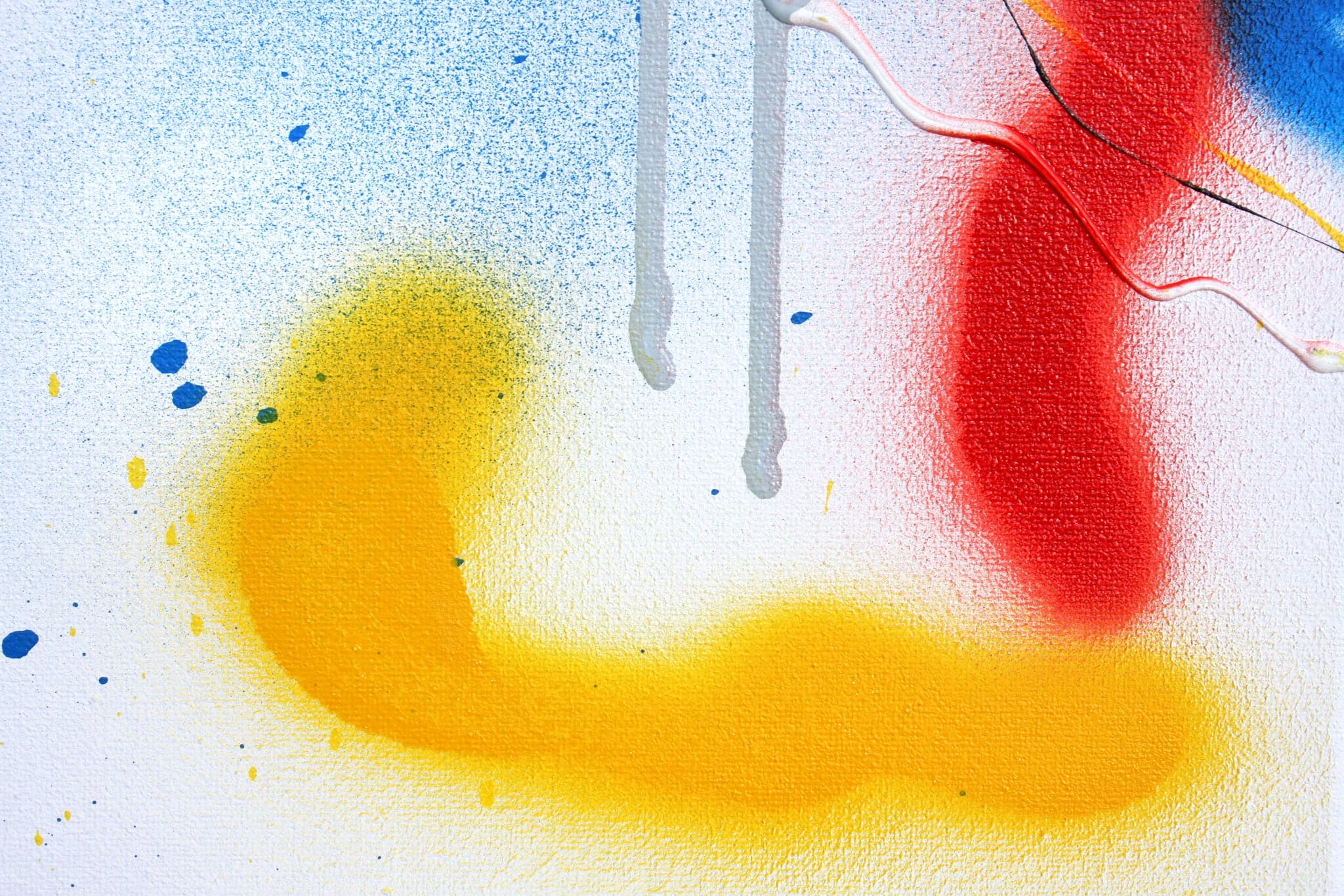 Close view: the curved yellow stroke and the grey drips falling through it.