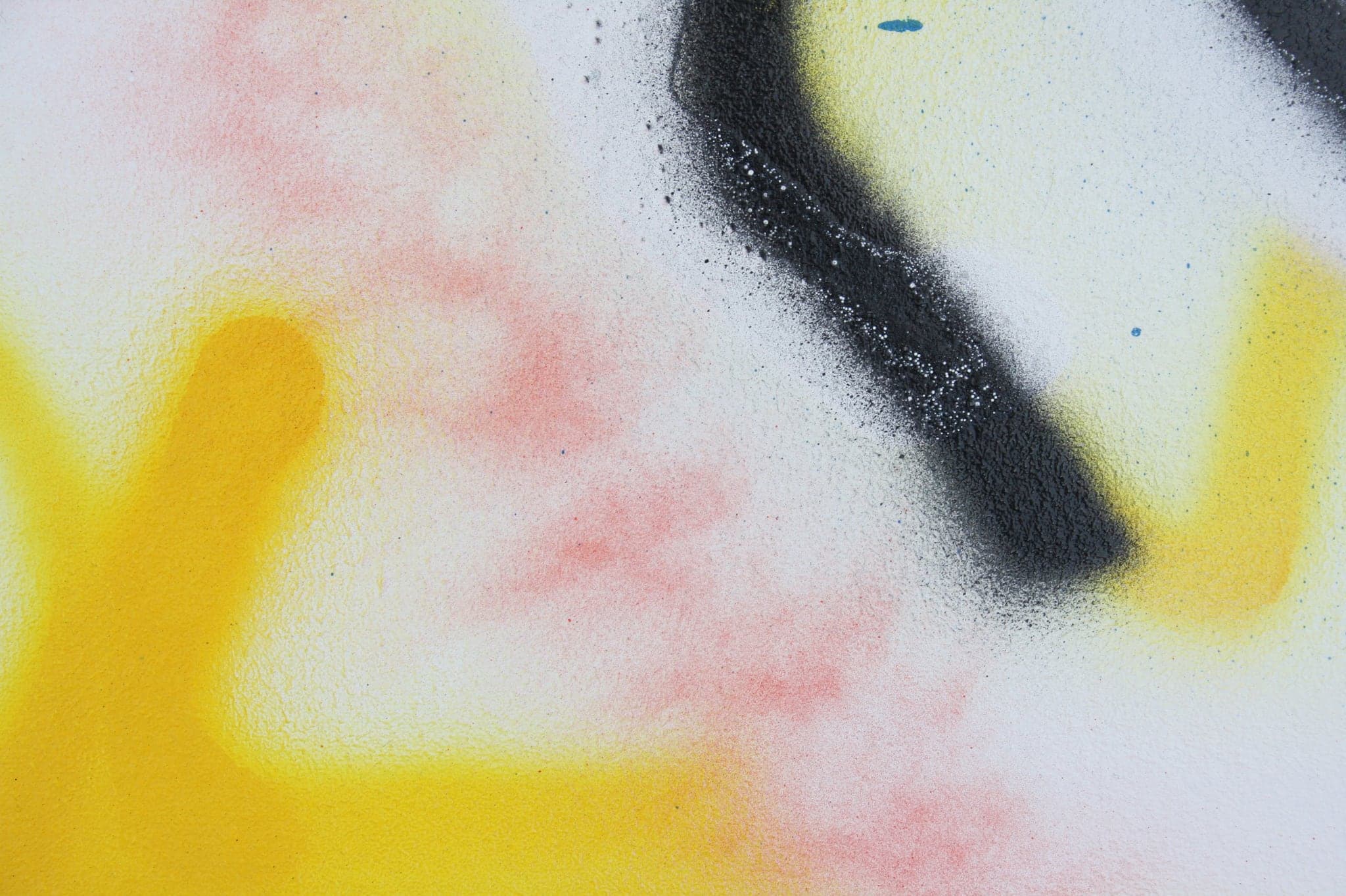Close view: a broad field of yellow with one black stroke laid across it.