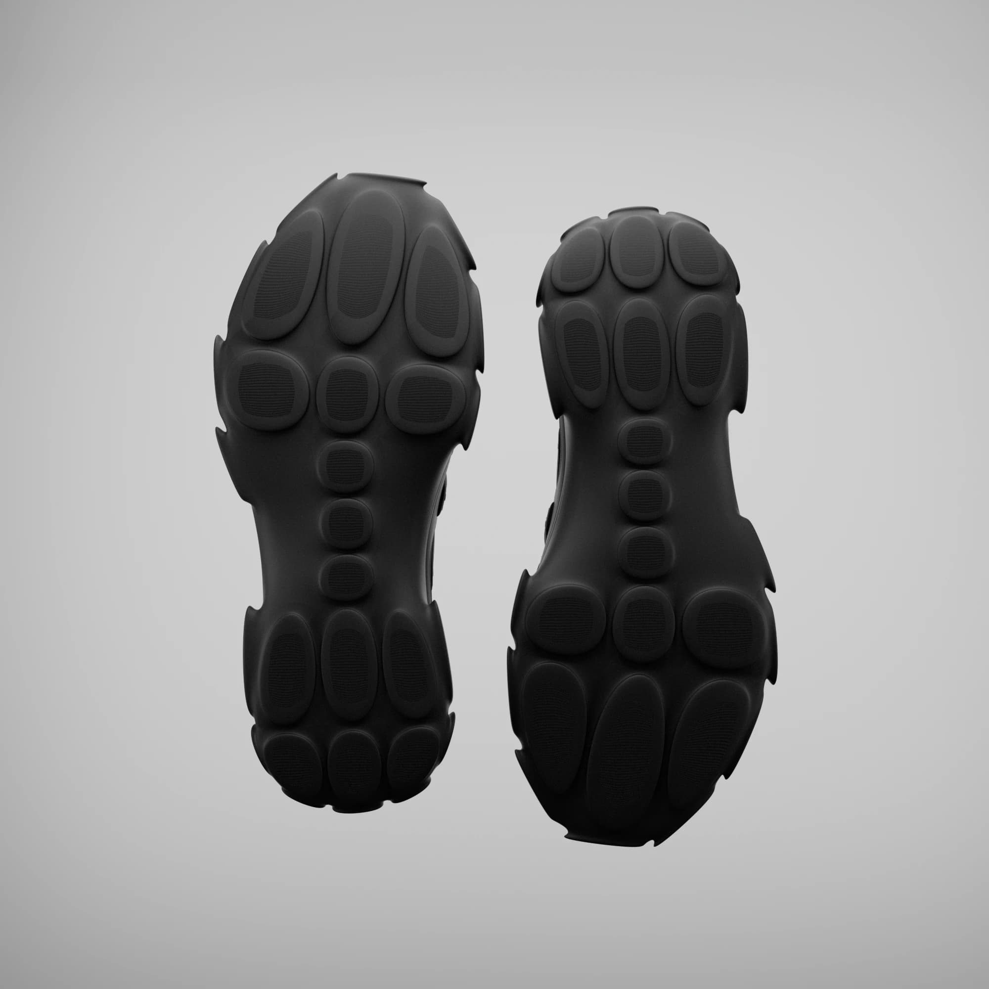 Undersides of both shoes: a black outsole covered in soft oval pads of varying size, with a serrated outline.