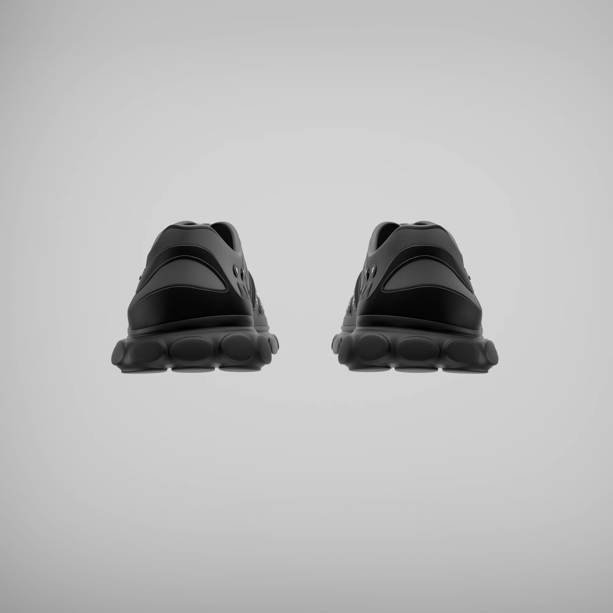 Rear view of the pair, showing the low heel counter and the lobed pads of the sole seen from behind.