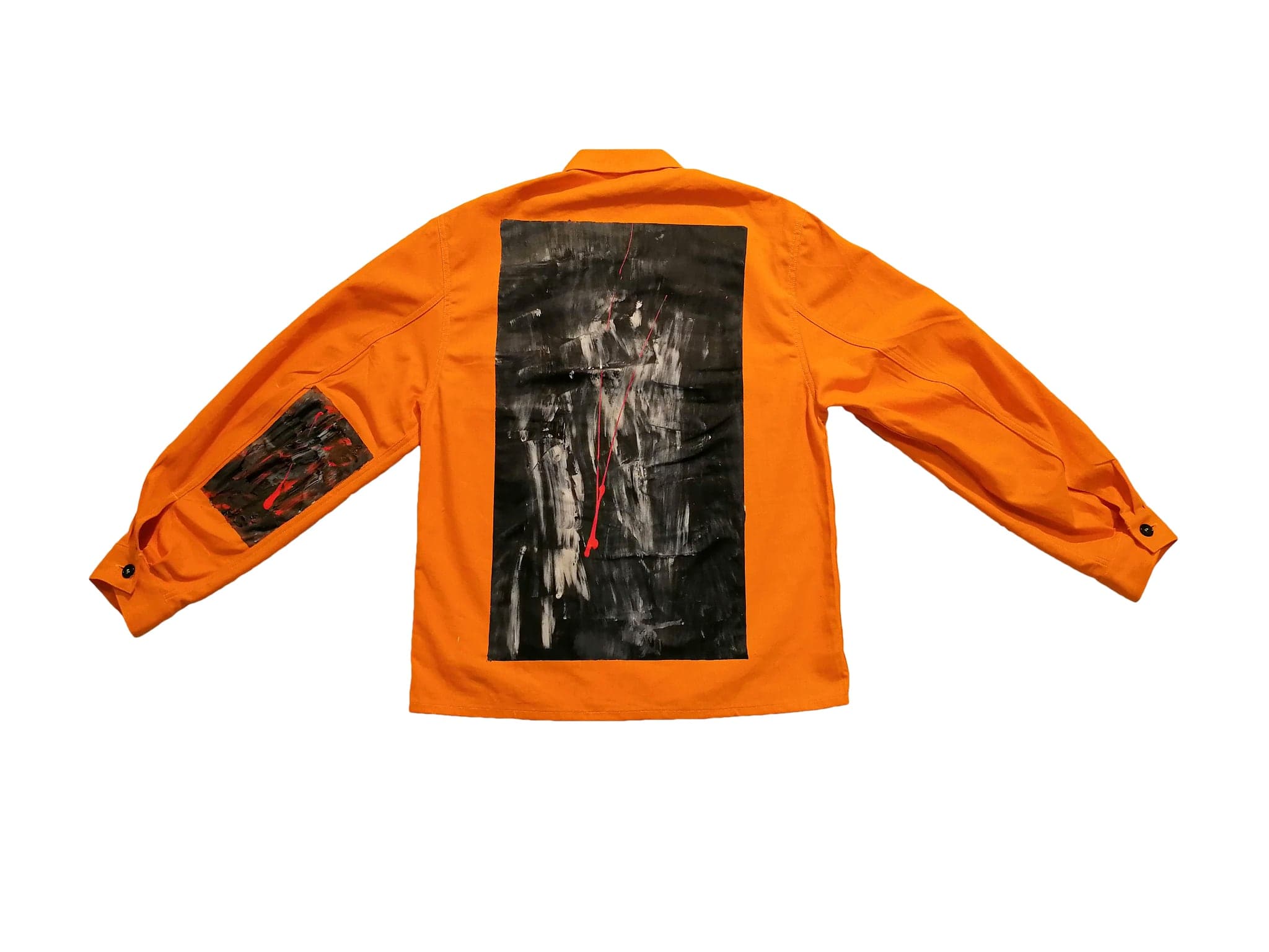 The back of the shirt flat on white, one large painted panel filling most of it