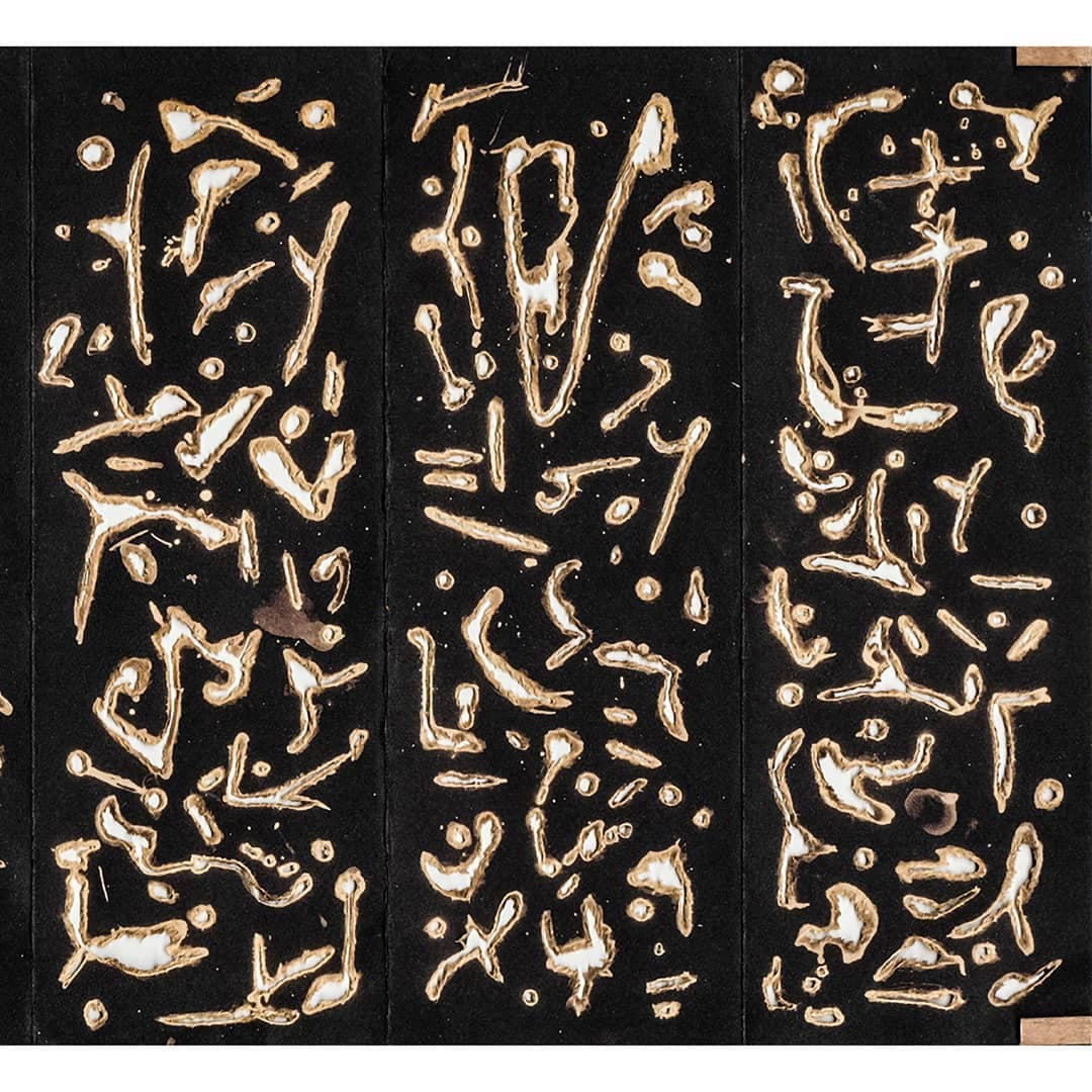 Three tall black panels side by side, each pierced with the same vocabulary of pale curved glyphs