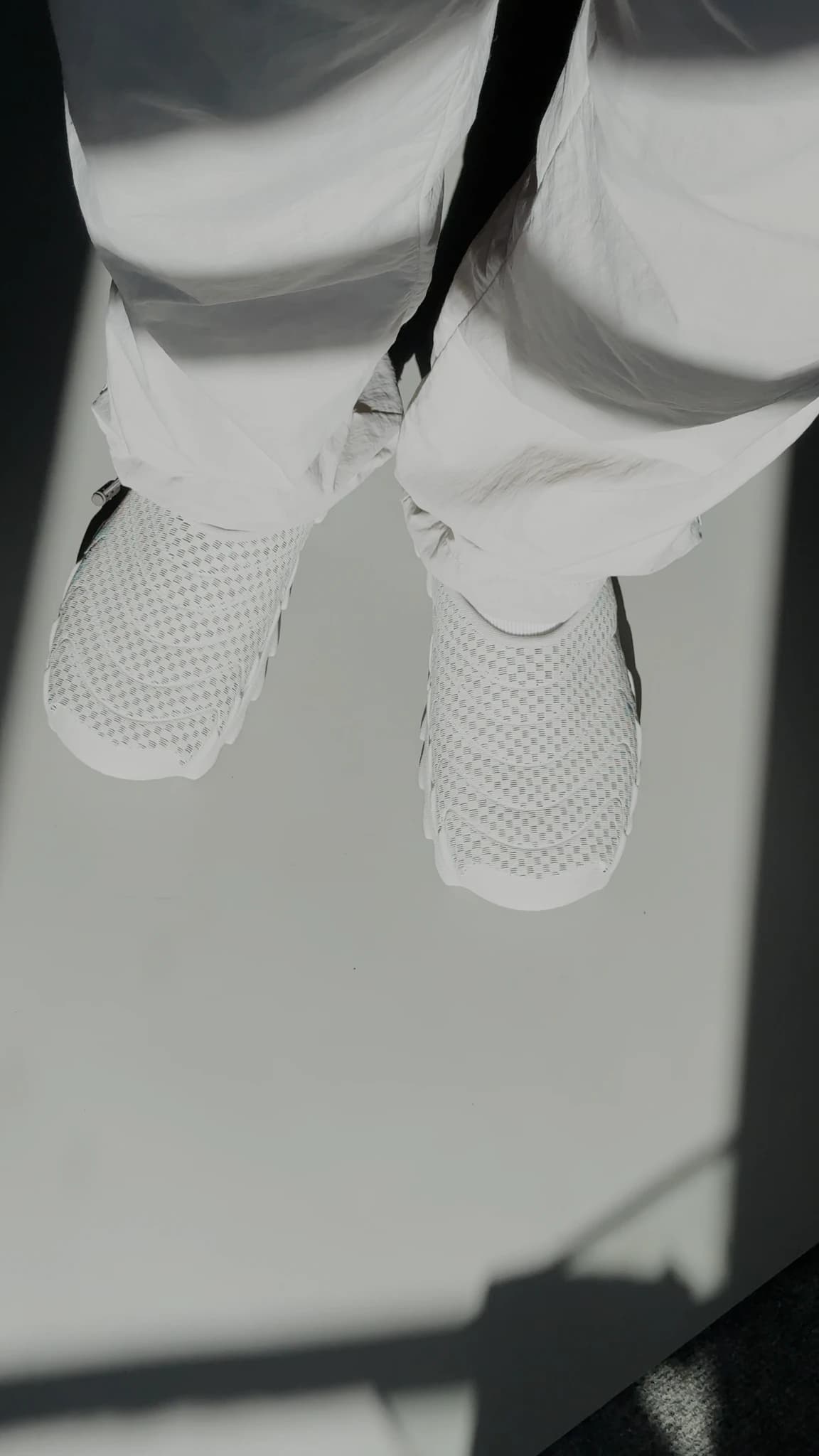Mid-step, one shoe lifted off the ground, the thick lugged sole tilted toward the camera
