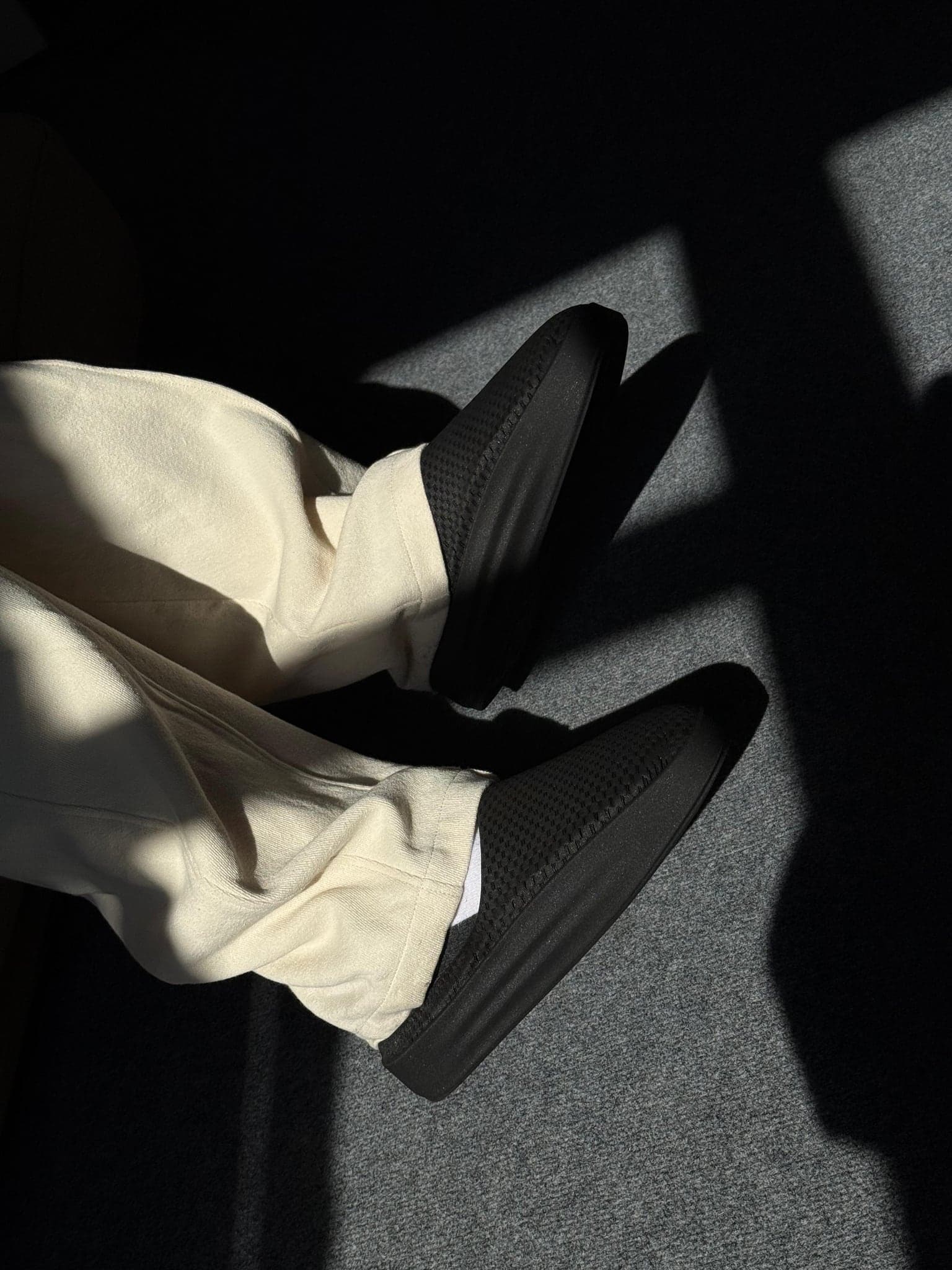 Wearing the printed shoes, photographed from above in raking light
